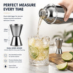 Pouring cocktail from the RüK shaker into a glass with ice, demonstrating precise measurement and smooth flow, background softly blurred.