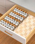 Clear acrylic spice drawer organizer with tiered trays for neatly storing spice jars in kitchen drawer