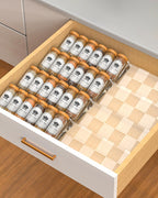 Clear acrylic spice drawer organizer with tiered trays for neatly storing spice jars in kitchen drawer