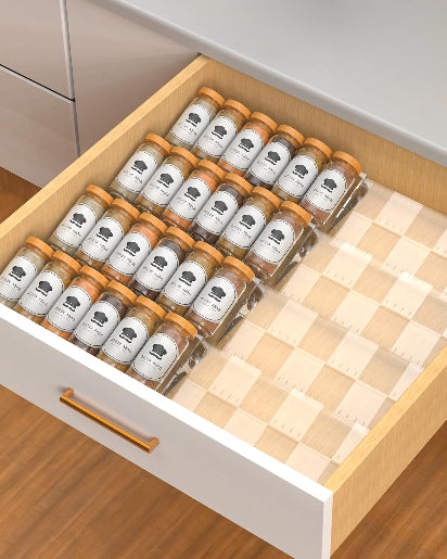 Clear acrylic spice drawer organizer with tiered trays for neatly storing spice jars in kitchen drawer