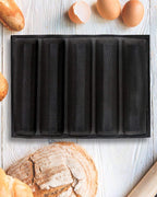 Freshly baked baguettes with golden crust made using a baguette baking tray
