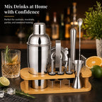 Freshly prepared cocktail in glass on bar counter with the 17-in-1 RüK cocktail shaker set in the background, creating a home bar lifestyle scene.