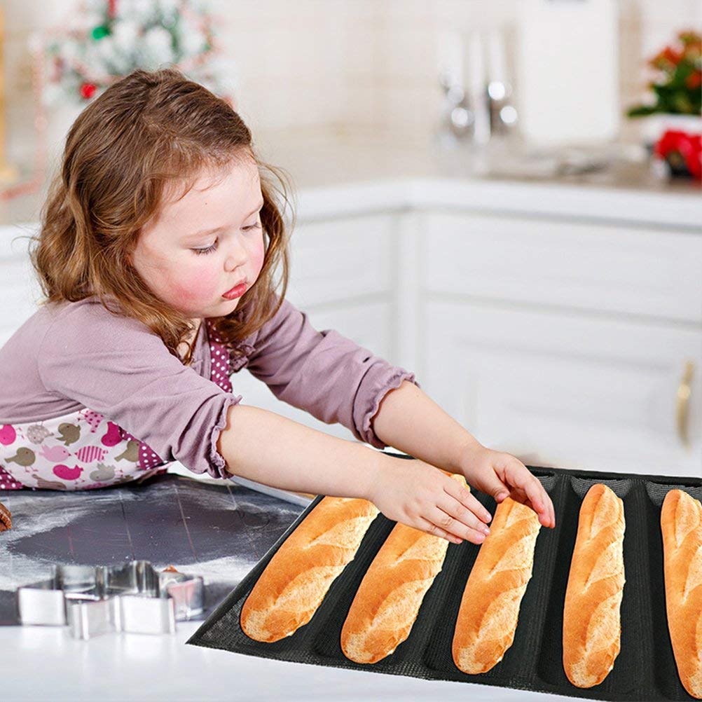Child baking bread with baguette pan in a home kitchen