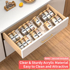 Clear acrylic seasoning drawer organizer holding spice jars neatly inside a kitchen drawer